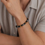 Man wearing a milestone birthday bracelet with black and brown beads