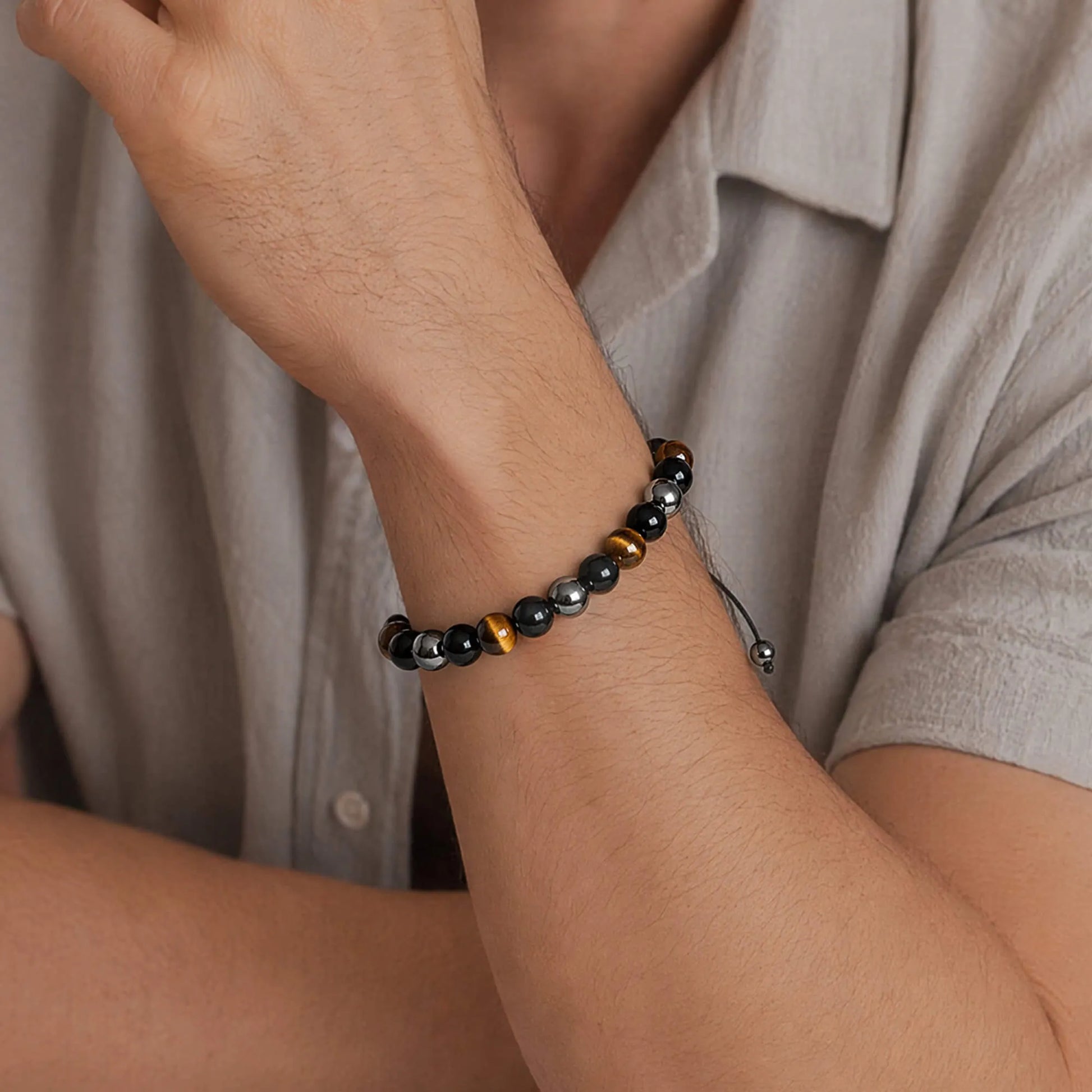 Man wearing a milestone birthday bracelet with black and brown beads