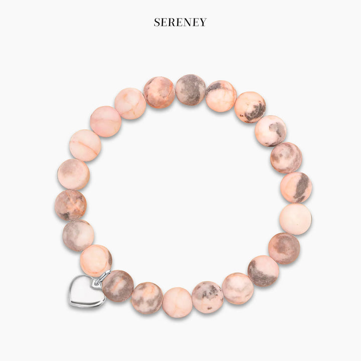 Bracelet featuring natural pink stones and silver-tone heart charm