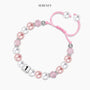 Pink pearl bracelet for first birthday with vendor name