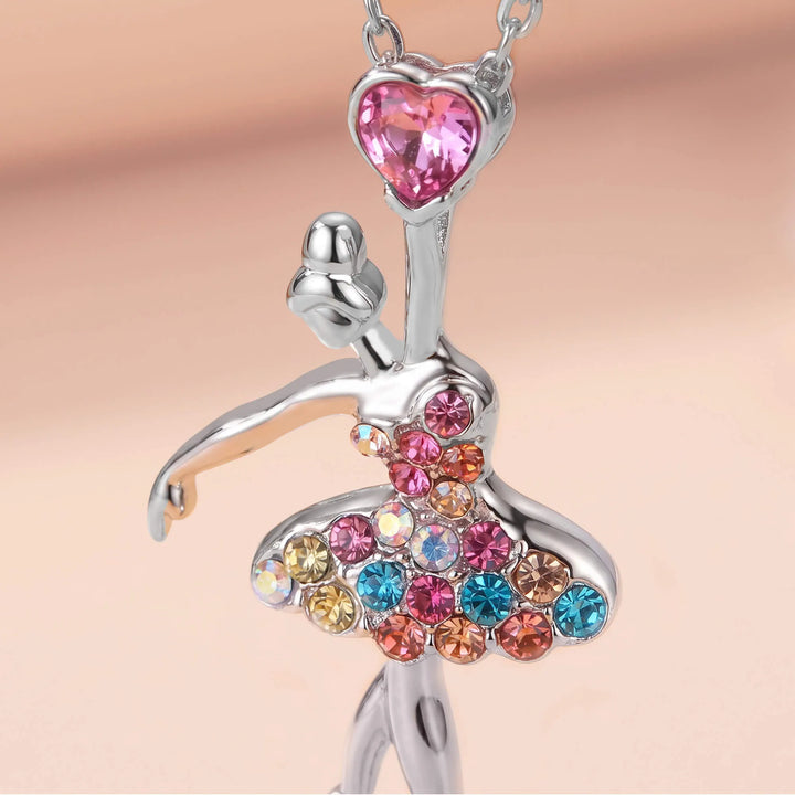 Close-up of ballerina pendant with colorful crystals and pink heart