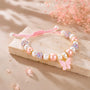 Adjustable bracelet with pink and white beads and butterfly charm