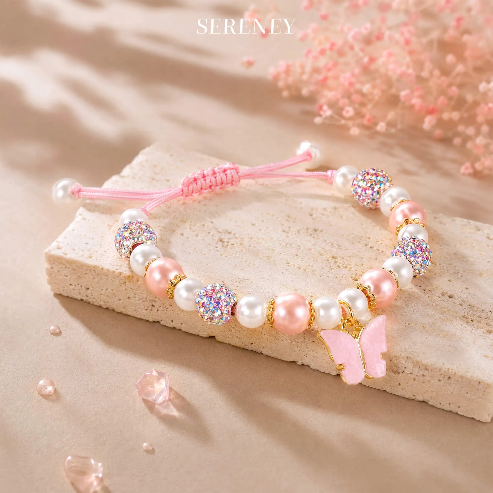 Adjustable bracelet with pink and white beads and butterfly charm