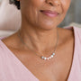 Woman wearing necklace with five crystal pearls