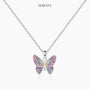 Silver-tone chain butterfly pendant necklace on a white card, centered view