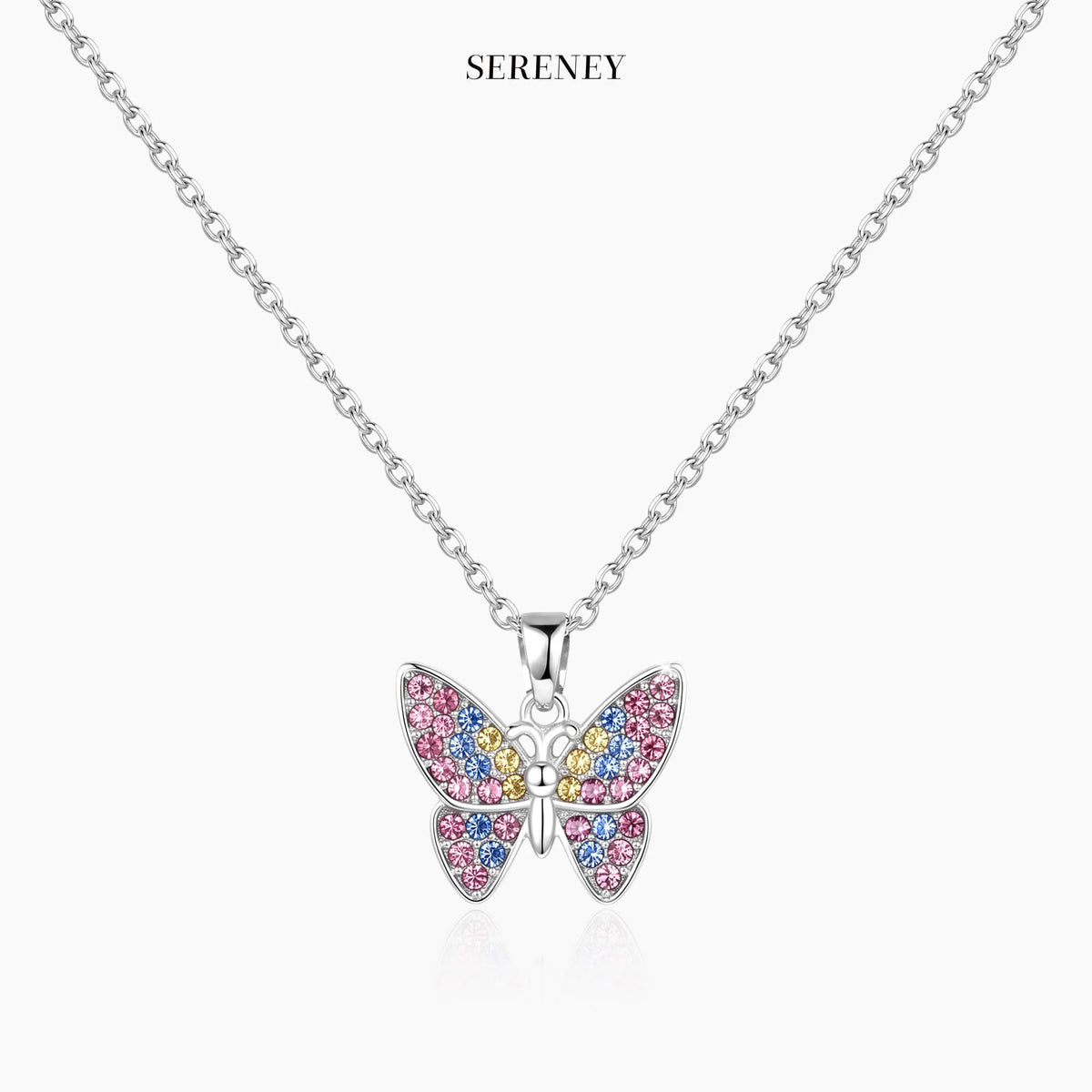 Silver-tone chain butterfly pendant necklace on a white card, centered view