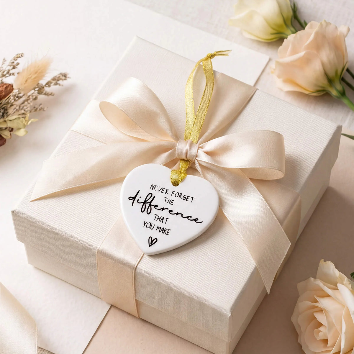 White ceramic heart keepsake with gold ribbon, shown as a gift tag
