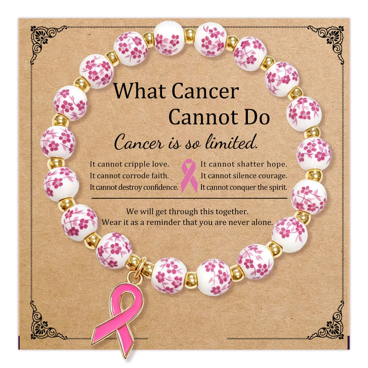 Pink ribbon charm beaded bracelet with white beads and gold spacers