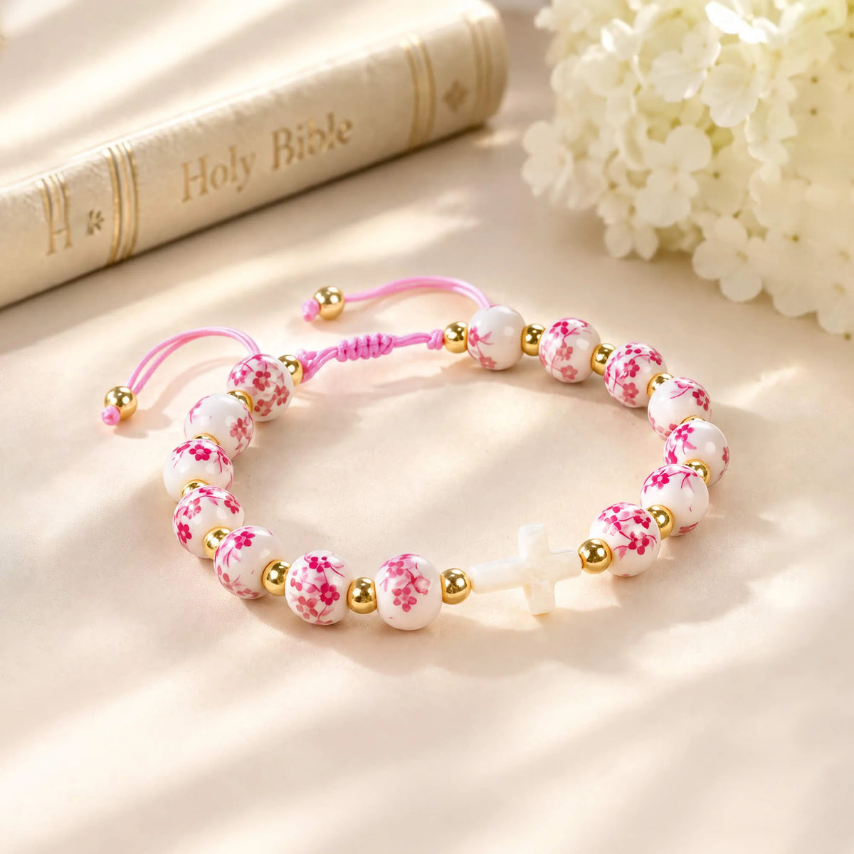 Pink cross beaded bracelet with pink cord and white/pink floral beads