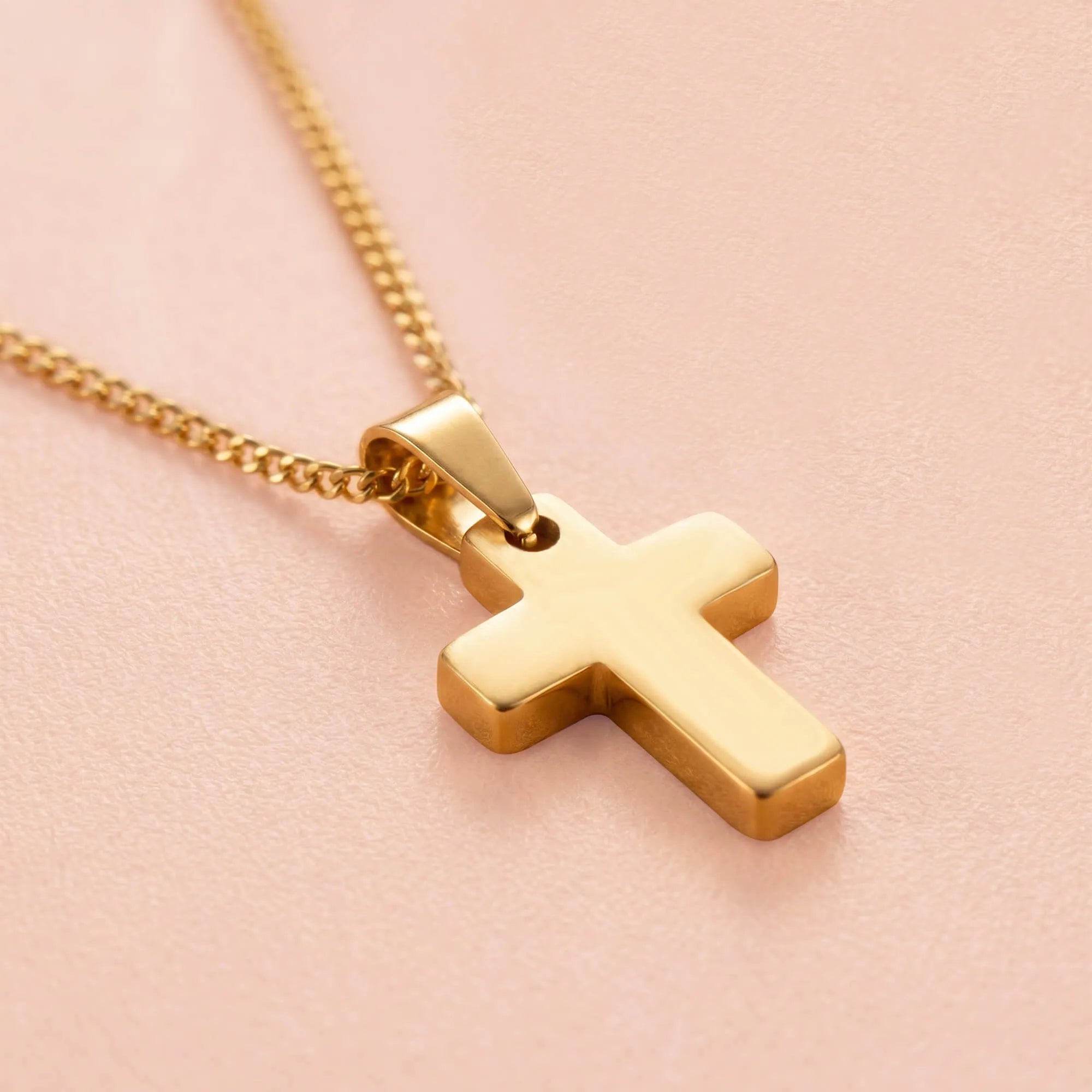 Close-up of gold-tone cross pendant on chain