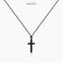 Black stainless steel cross necklace displayed on a white background