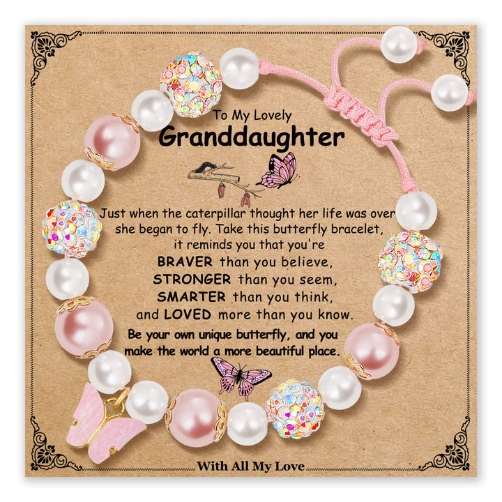 Bracelet with pink butterfly charm and pearl beads on a card