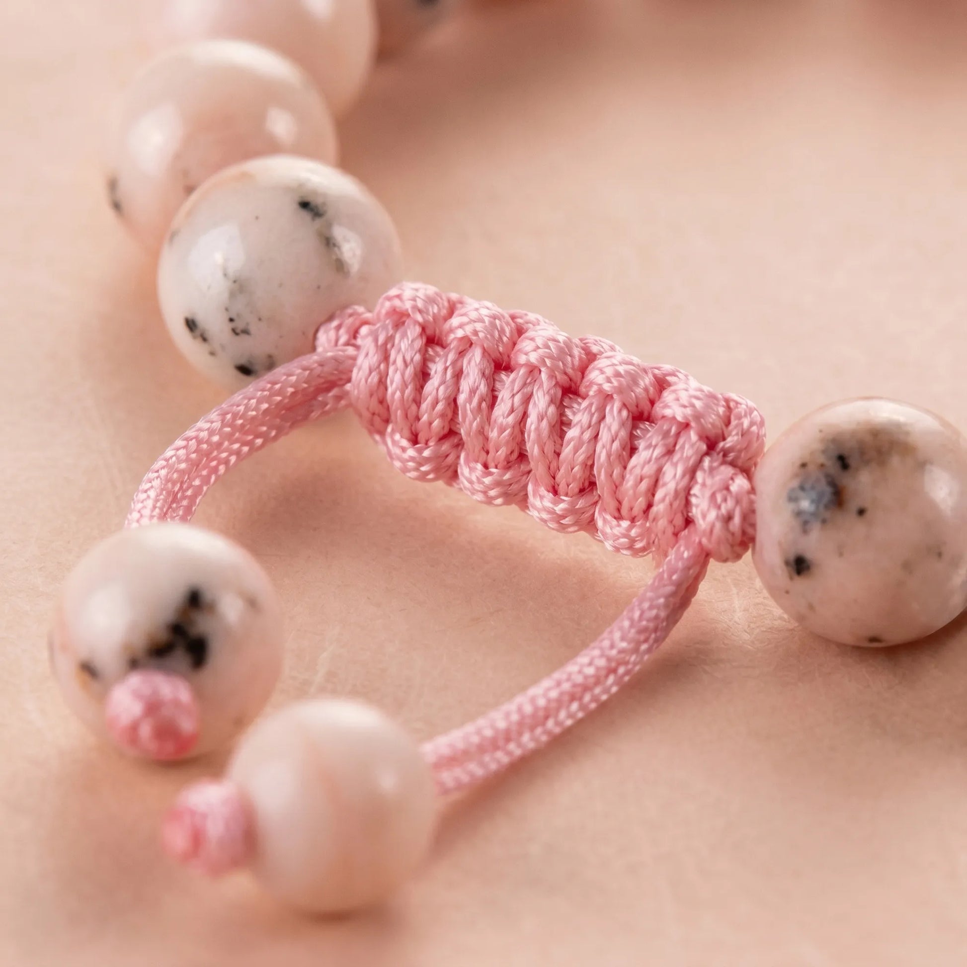Close-up of sliding knot clasp on pink pearl bracelet