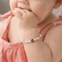 Little girl wearing Berry Sweet Birthday Bracelet