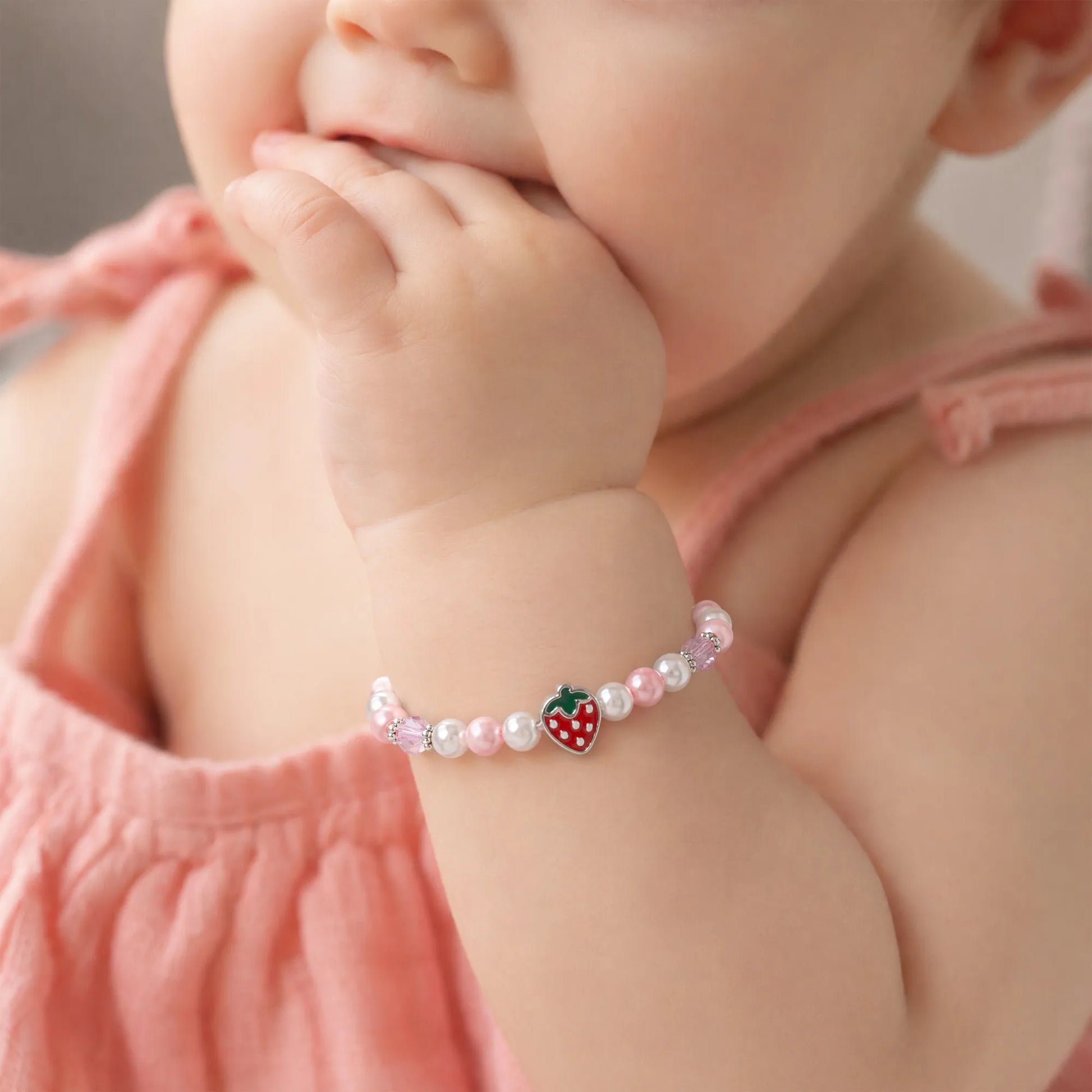 Little girl wearing Berry Sweet Birthday Bracelet