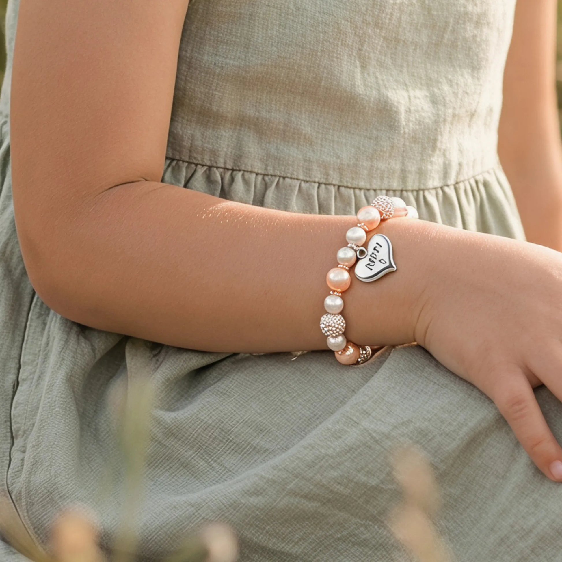 Girl wearing Magical Zebra Jasper Birthday Bracelet for 5th birthday in outdoor setting