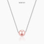 Pink crystal pearl necklace displayed on a light background