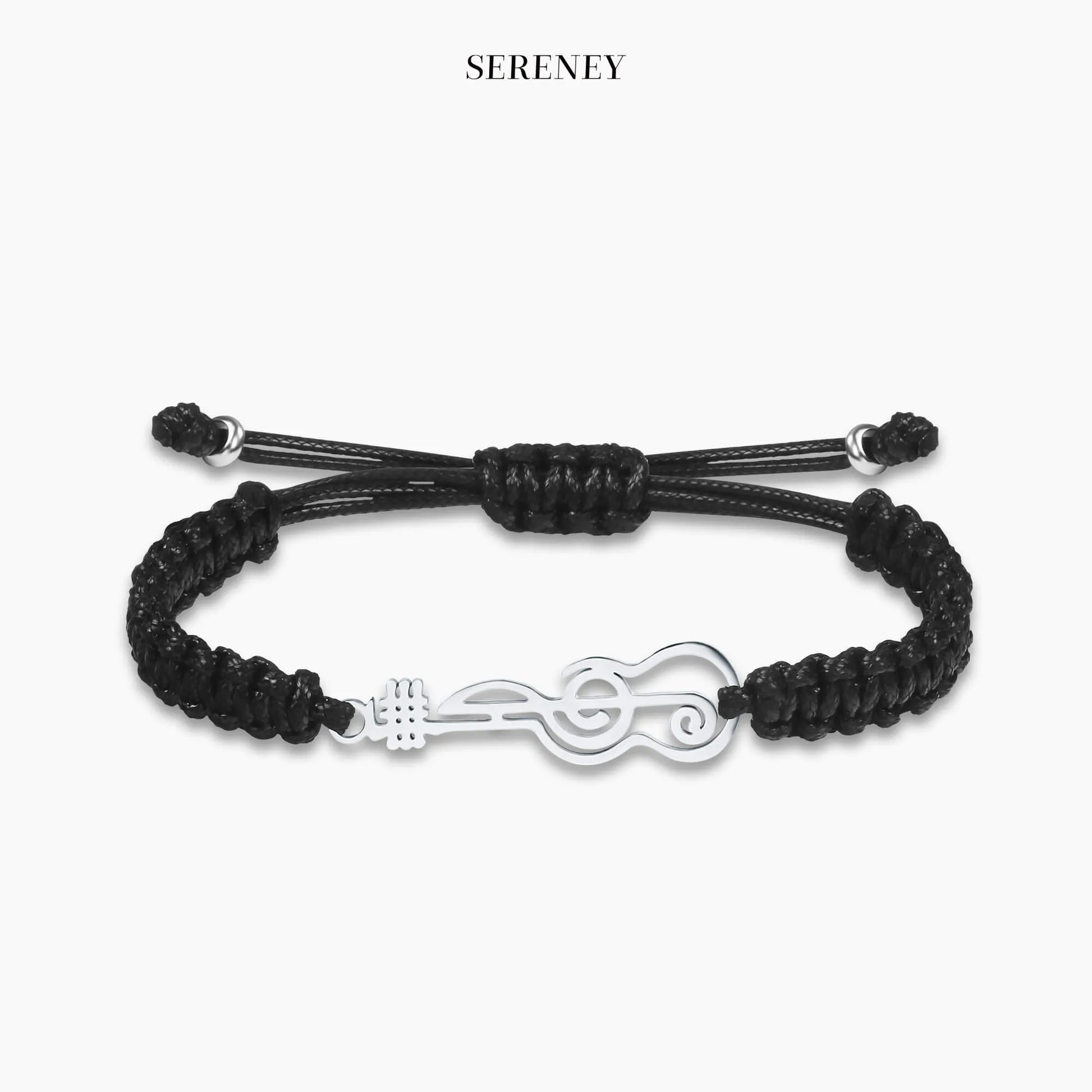 Black bracelet with guitar charm on a neutral background