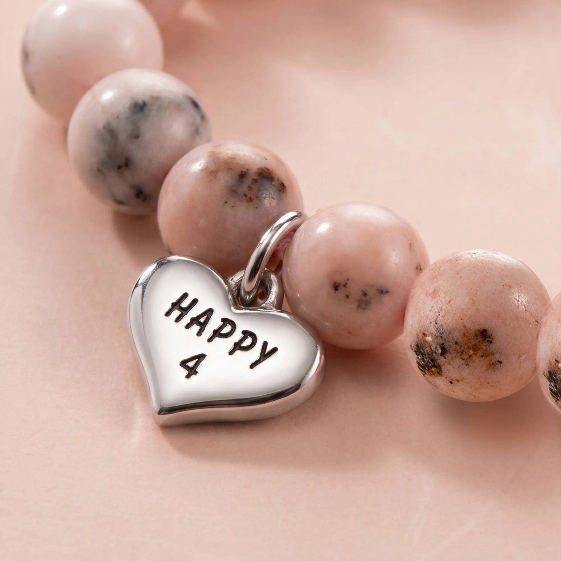 Close-up of Magical Zebra Jasper Birthday Bracelet showing heart pendant