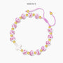 Pink cord beaded bracelet with gold accents and white beads with pink floral print