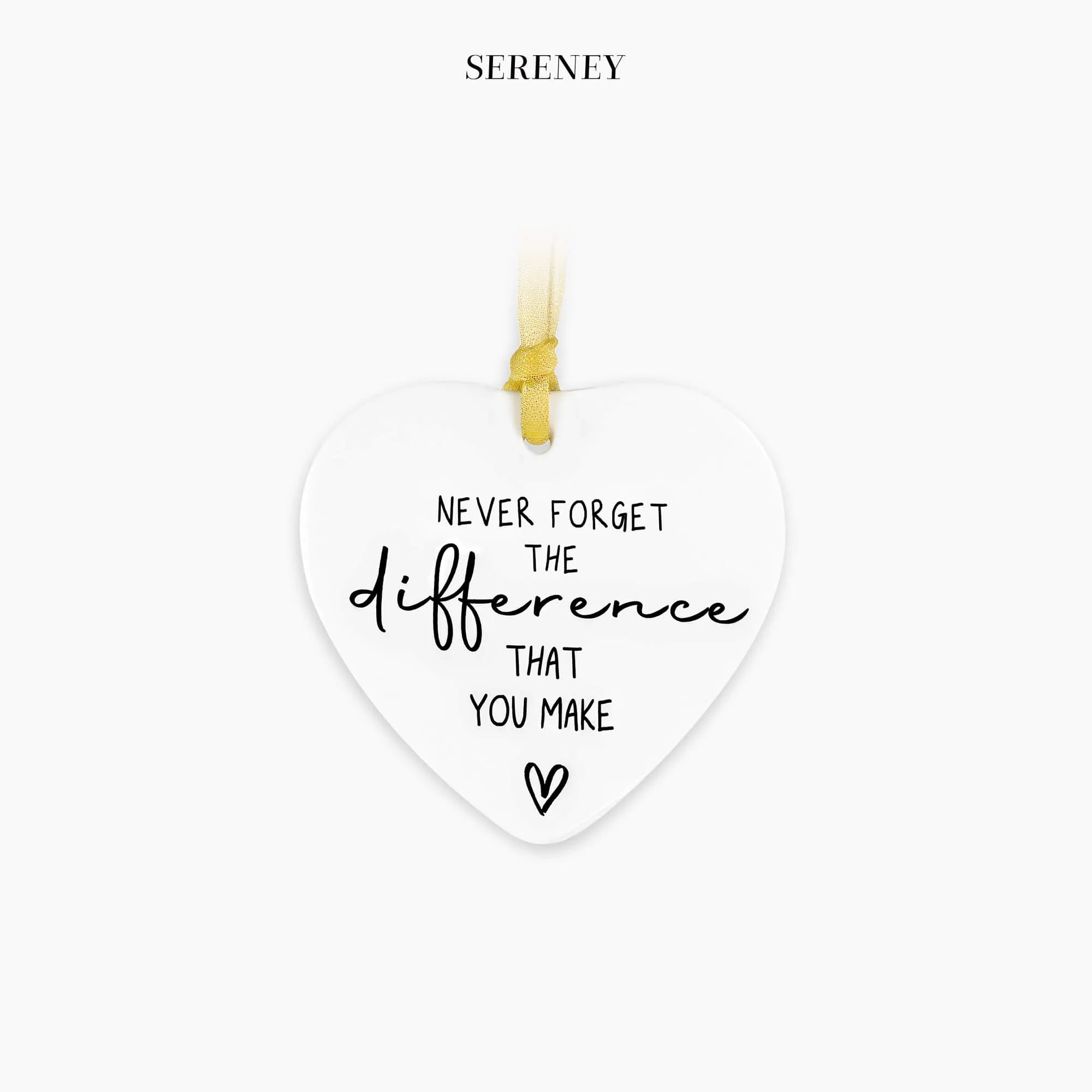 White heart-shaped ceramic keepsake with gold ribbon and an inspirational message
