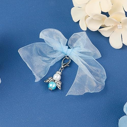 Angel charm with blue ribbon on blue background