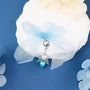 Angel charm on white gift with blue ribbon