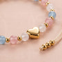 Close-up of bracelet showing heart charm and beads