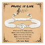White braided charm bracelet with treble clef charm