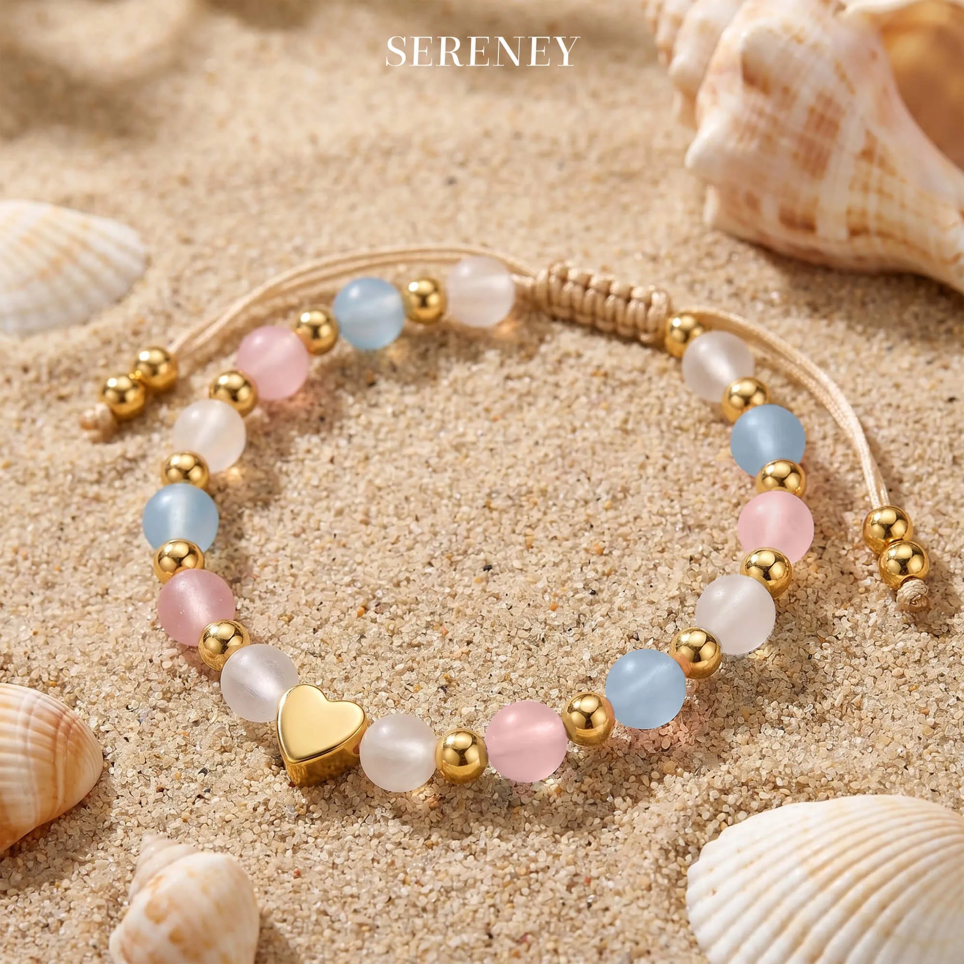 Adjustable bracelet featuring rose quartz, aquamarine, and moonstone beads with a gold heart charm