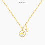 Gold necklace featuring mountain and cross charm