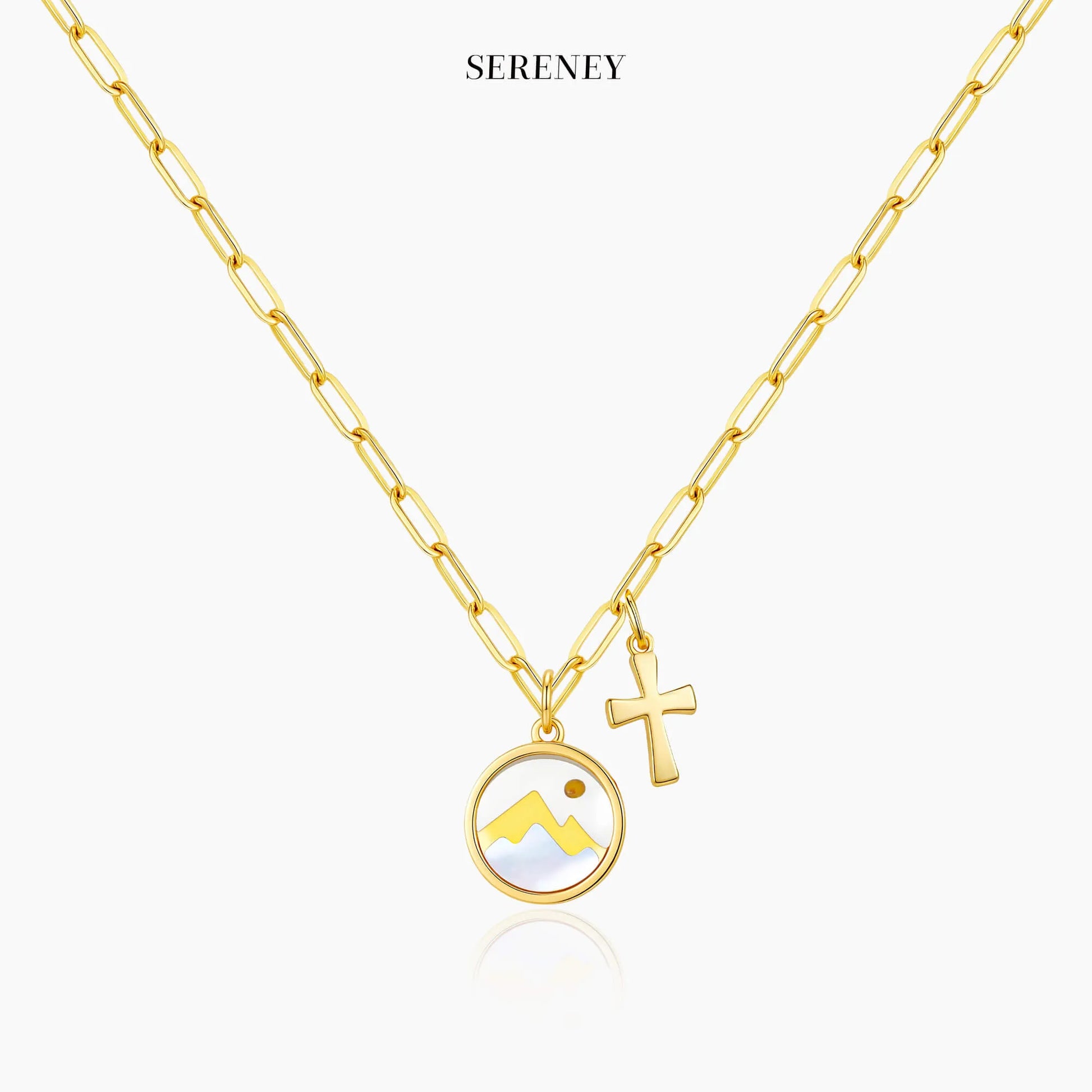 Gold necklace featuring mountain and cross charm