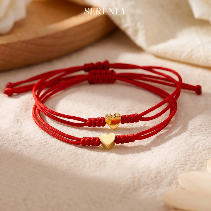 Heart charm red bracelet set displayed on a surface