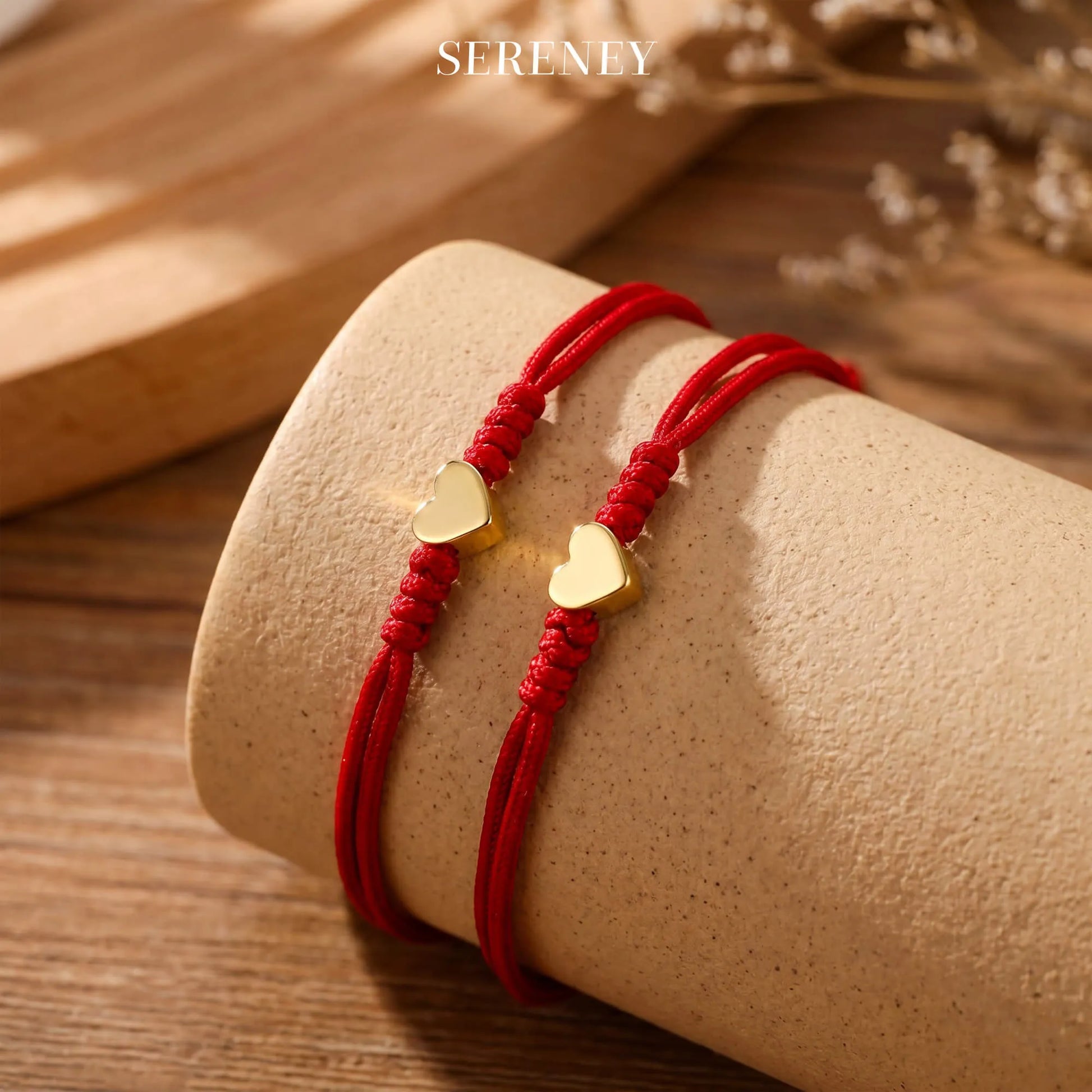 Heart charm red bracelets on a cylindrical surface