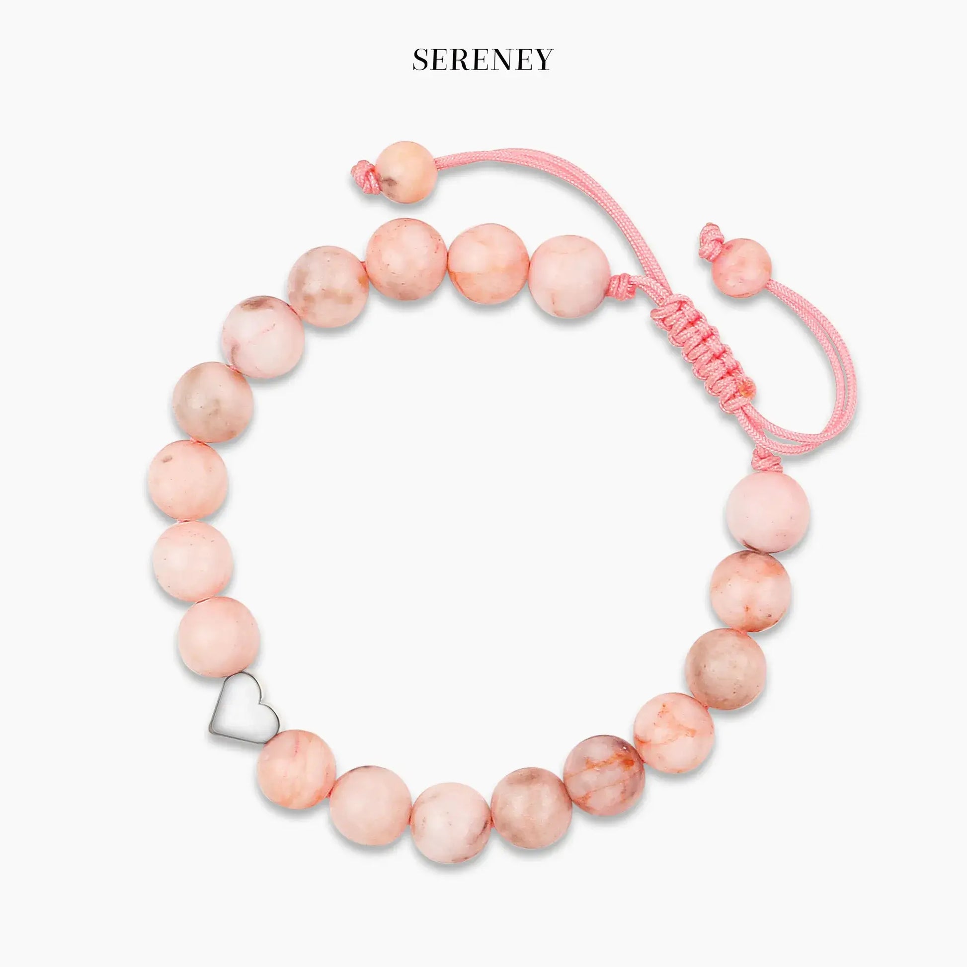 Pink zebra jasper bracelet with heart pendant on display