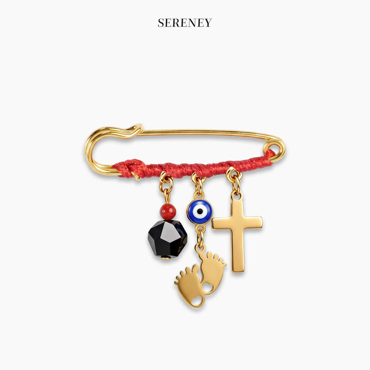 Close-up of gold Triple Threat Amulet Pin with red string