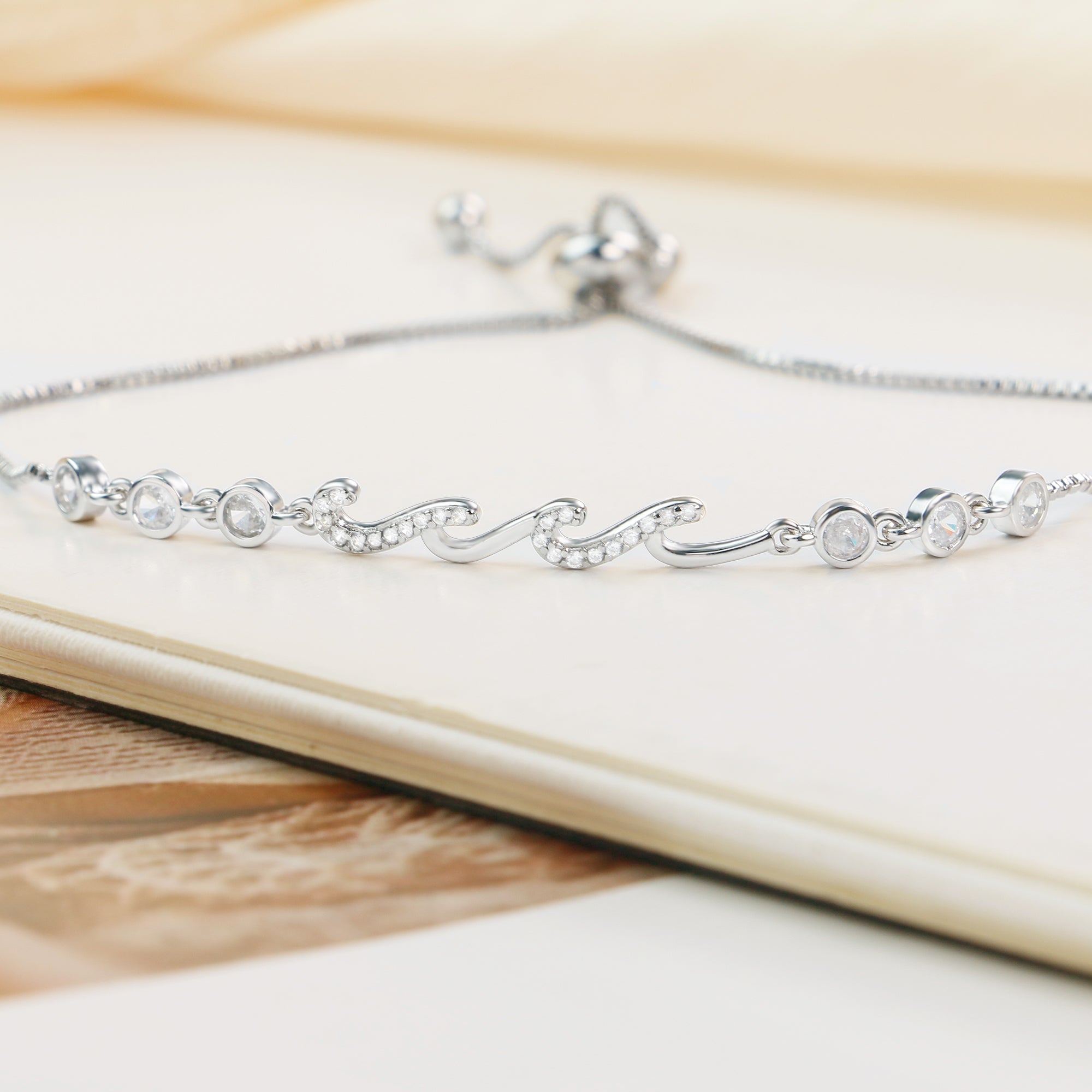 Close-up of silver bracelet on a book